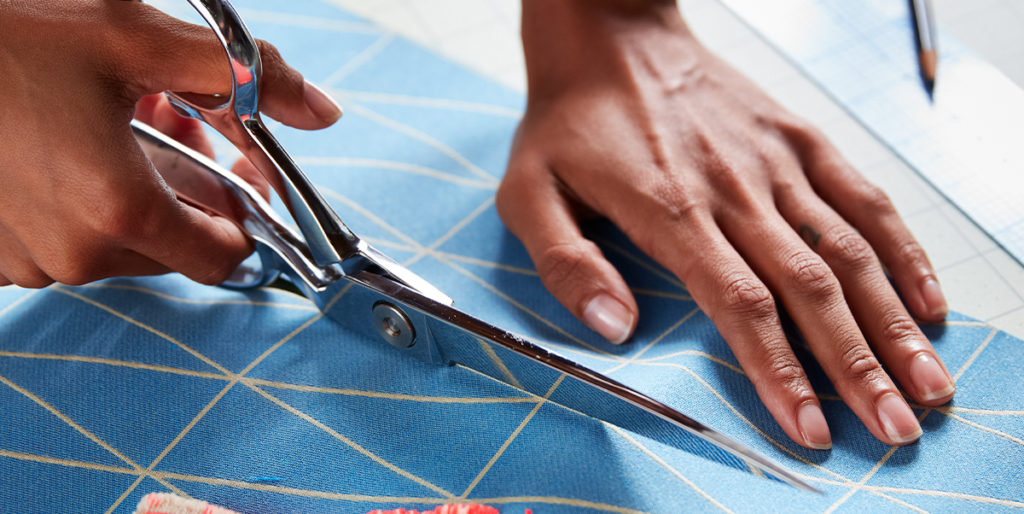 Cutting blue upholstery fabric.