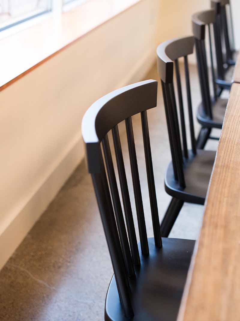 Side view of black Hugh chairs.