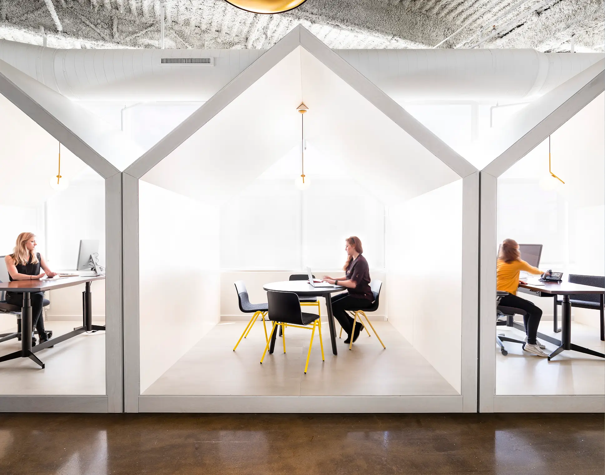 Corporate office with yellow base Harper chairs.