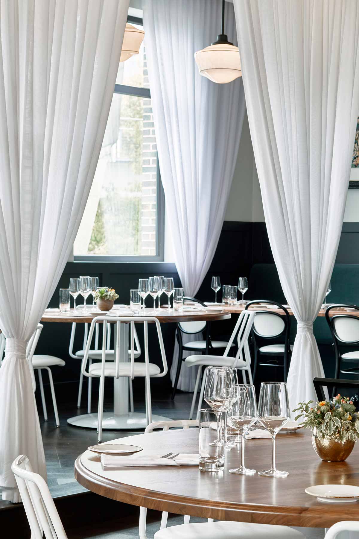 Whitebird restaurant with white Leo Chairs.