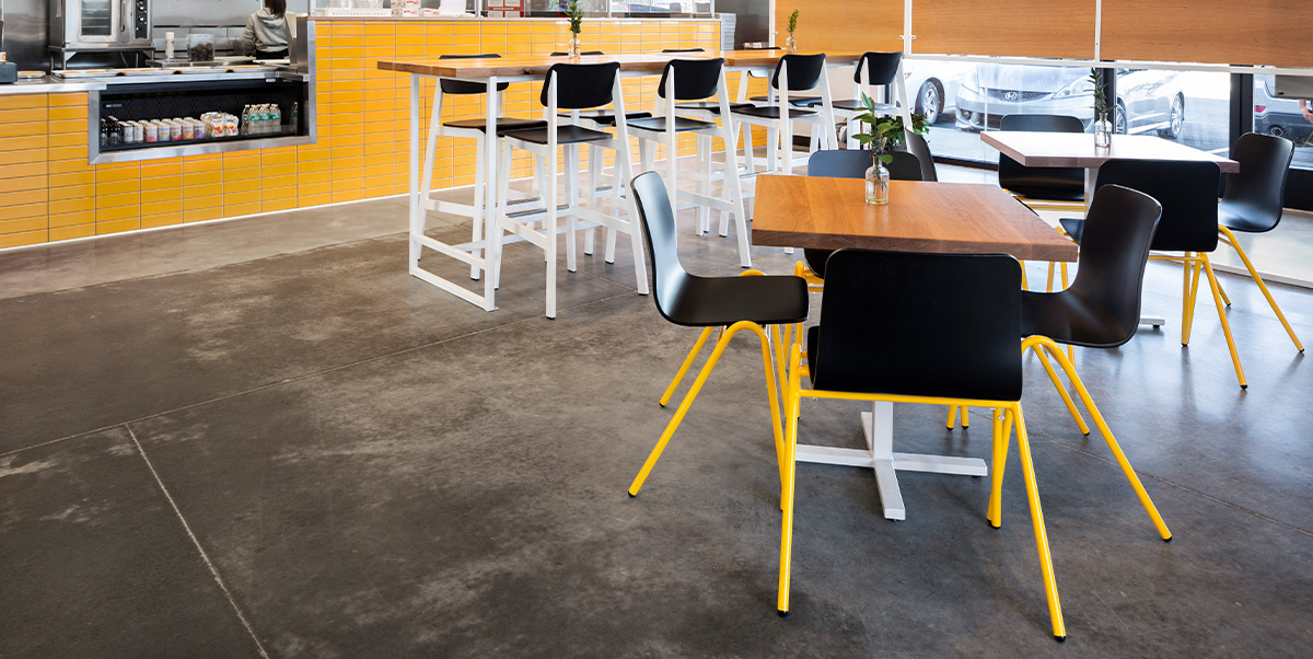 Harper A- Frame Chairs with black shell and yellow legs.