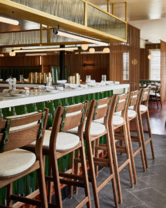 Sigsbee Barstools with green straps at restaurant bar.