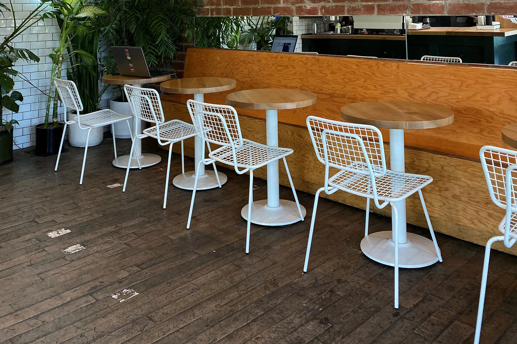 Row of white Hula Chairs in coffee shop.