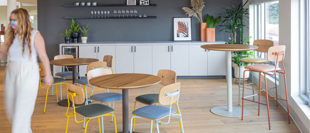 Modern office cafeteria with colorful industrial-inspired reece chairs and stools