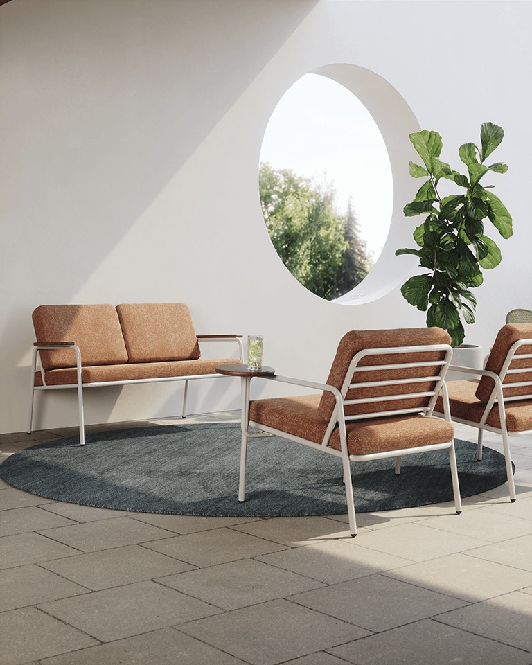 Outdoor space with orange Rita Loveseat and Lounge Chairs