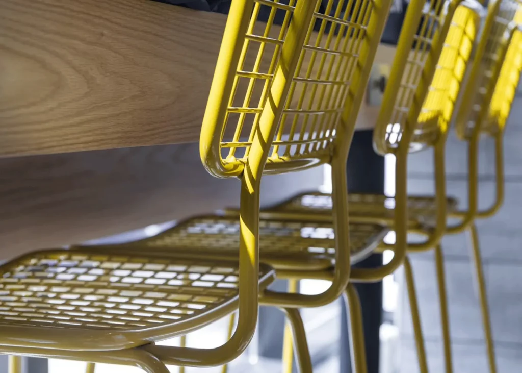 Close-up of yellow Opla Outdoor Chairs.