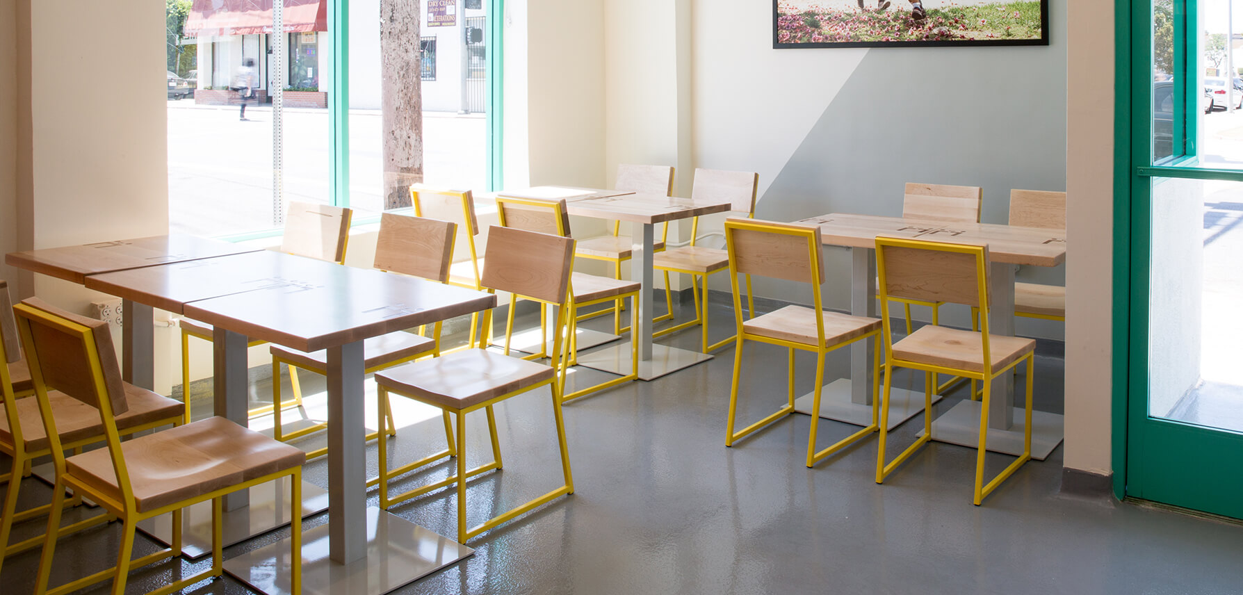 Brady Chairs with natural wood and yellow frames in restaurant.
