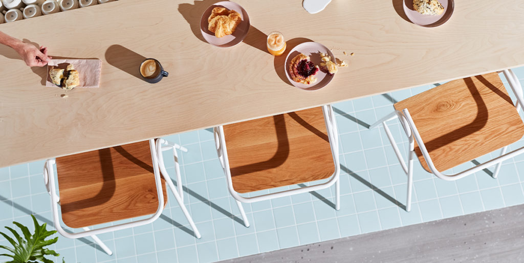 Aerial view of restaurant harvest table with chairs.