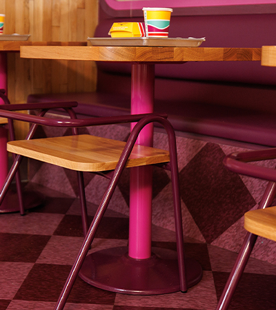 Cassandra table with wood top and fuchsia base.