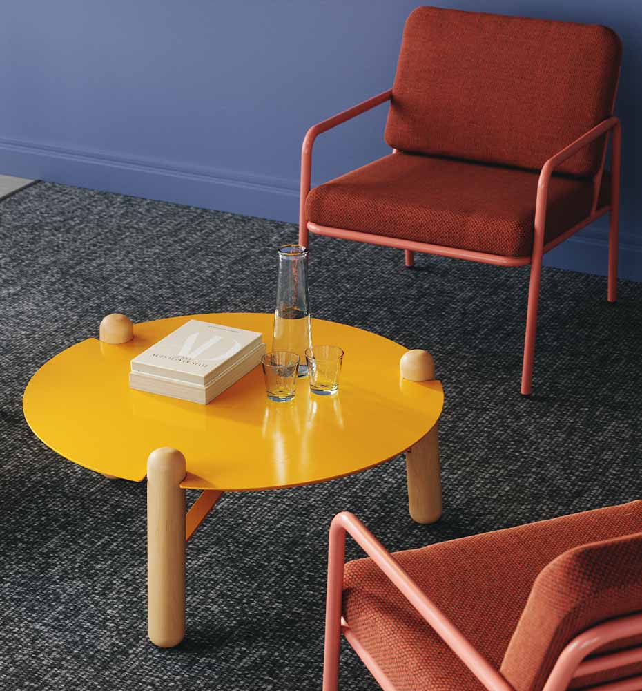 Louis Occasional Table with yellow surface and natural legs.