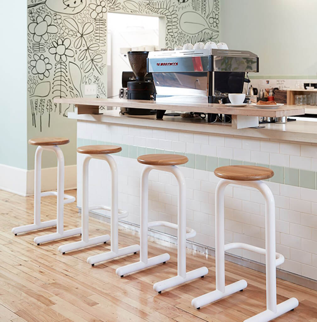 Coffee bar featuring Sir Burly stools with wood seat and white base.