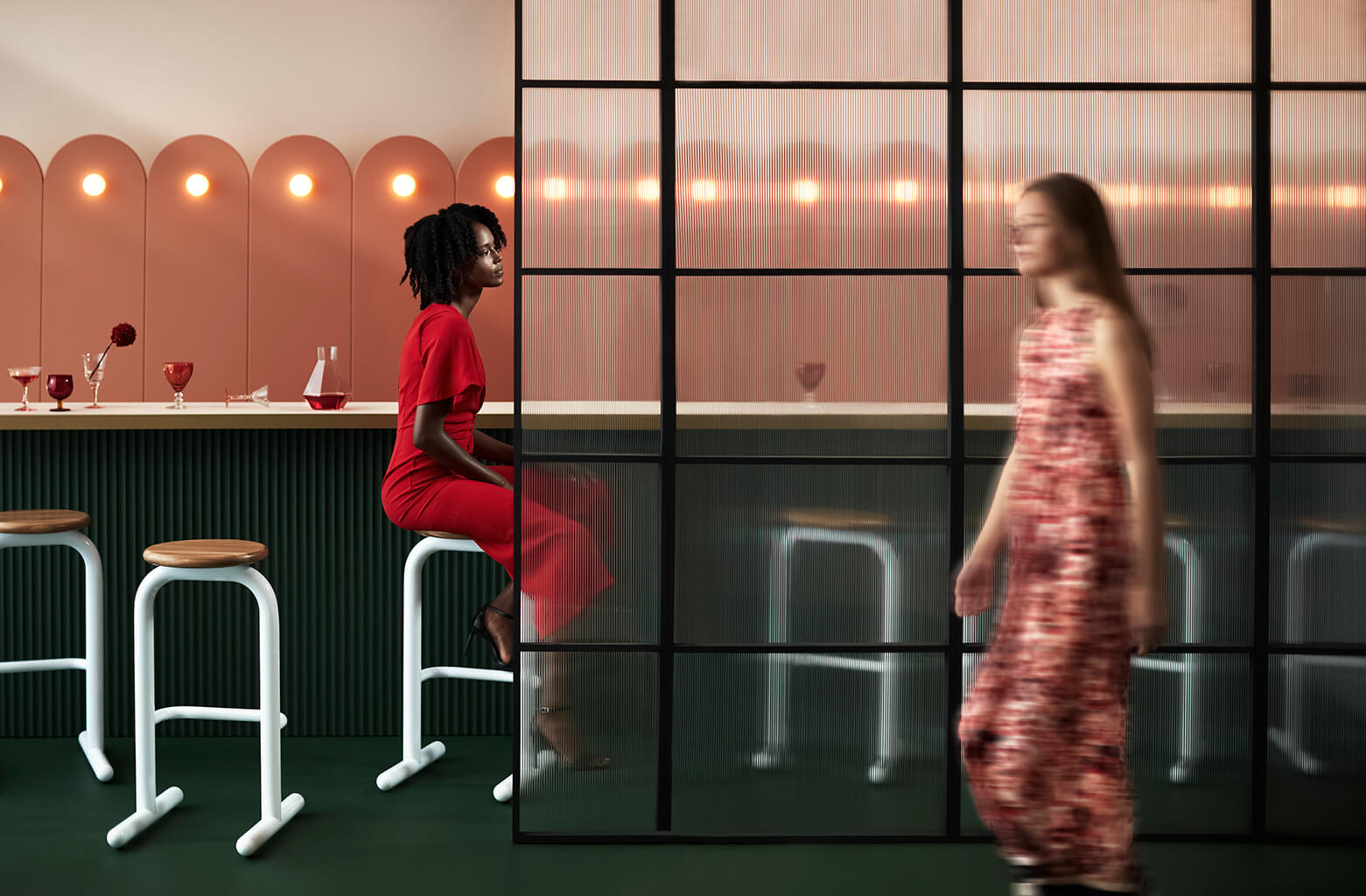 Woman sitting at bar with Sir Burly stools.