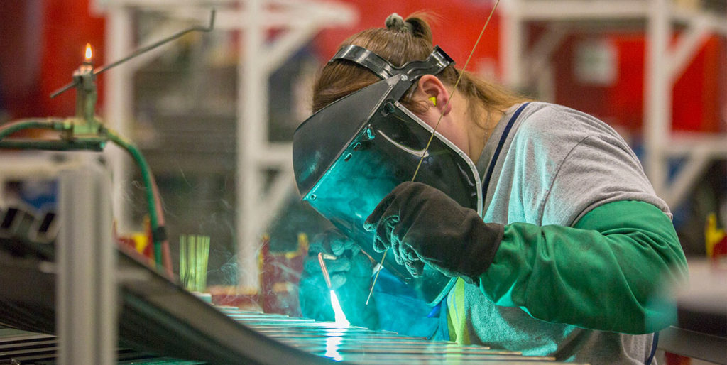 Grand Rapids chair employee welding chair.