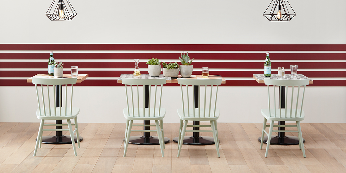 Set of white Hugh Chairs in cafe setting.