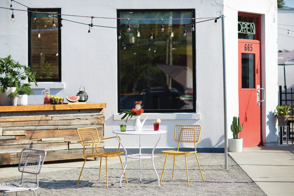 Outdoor cafe with yellow Opla chairs and armchair.