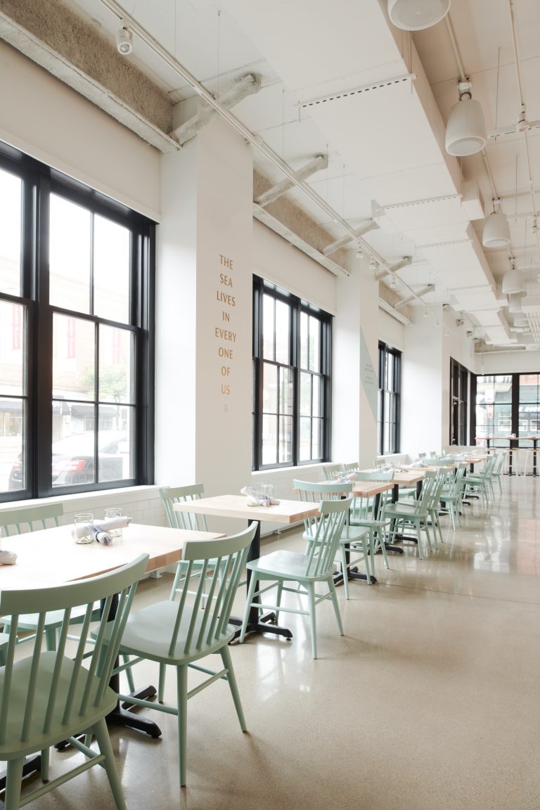 Restaurant dining room with mint green Hugh chairs.