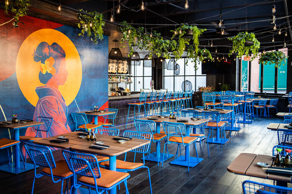 Bowen Pedestal Tables with blue bases and blue Opla seating.