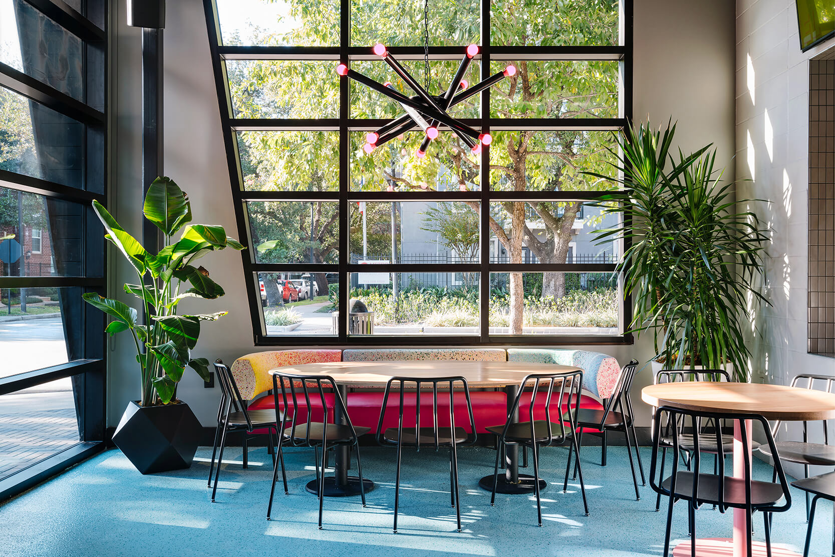 Collection of black Leo chairs in retro restaurant.