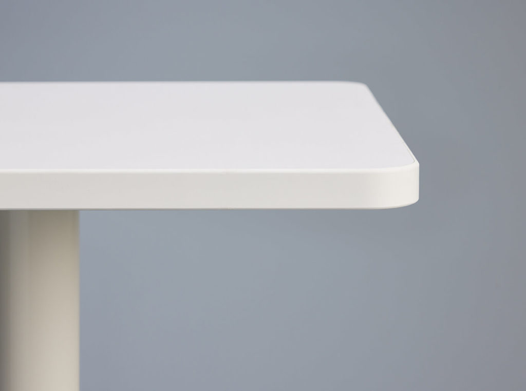 Onesima table edge with white laminate.