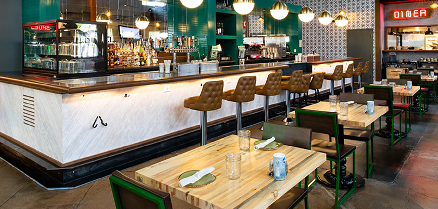 Restaurant and bar featuring green brady chairs.