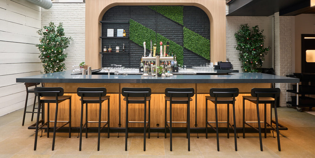 Restaurant bar with set of black Ferdinand bar stools
