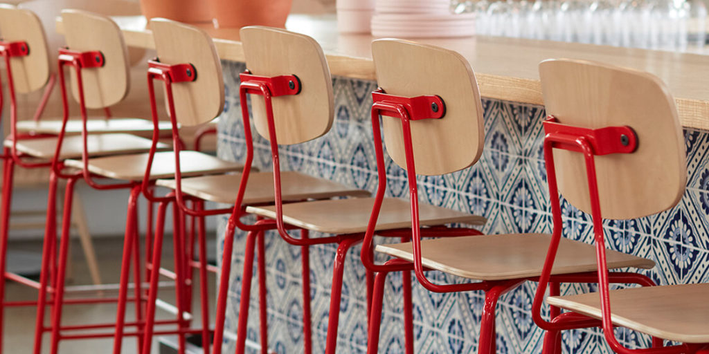 Row of Reece Barstools with red frames.