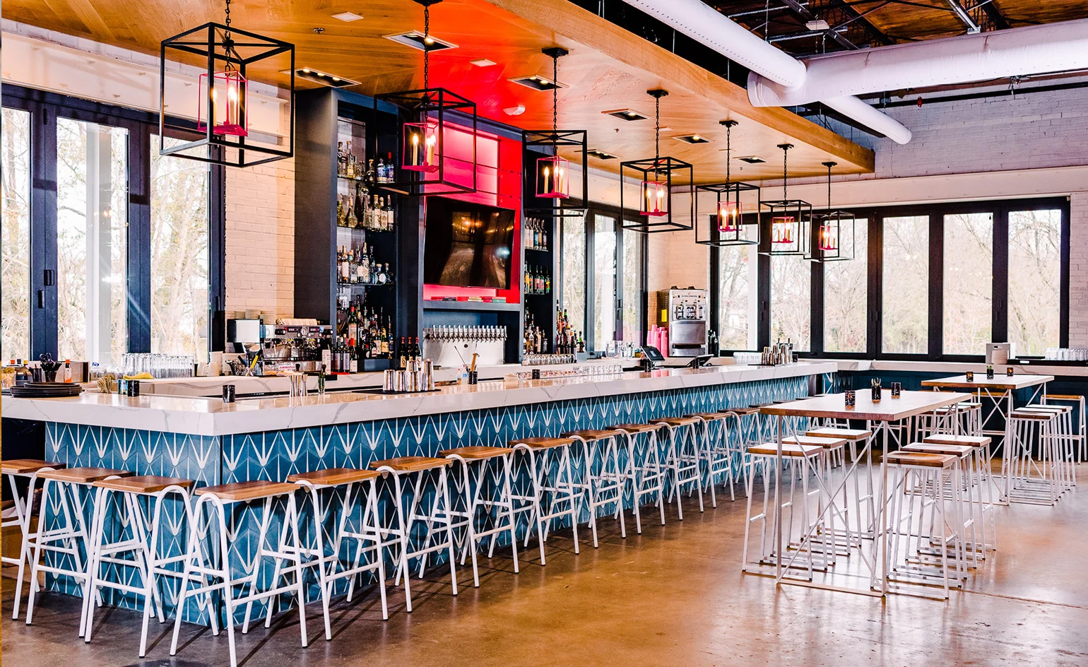 Hurdle Barstools with white bases at restaurant bar.