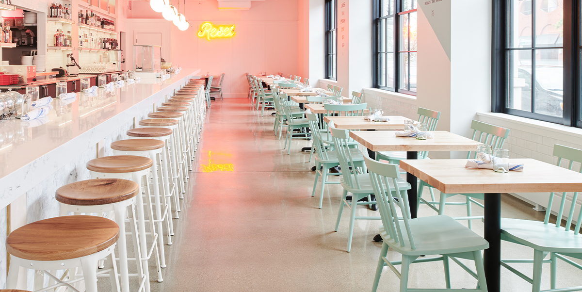 Restaurant with green Hugh chairs.