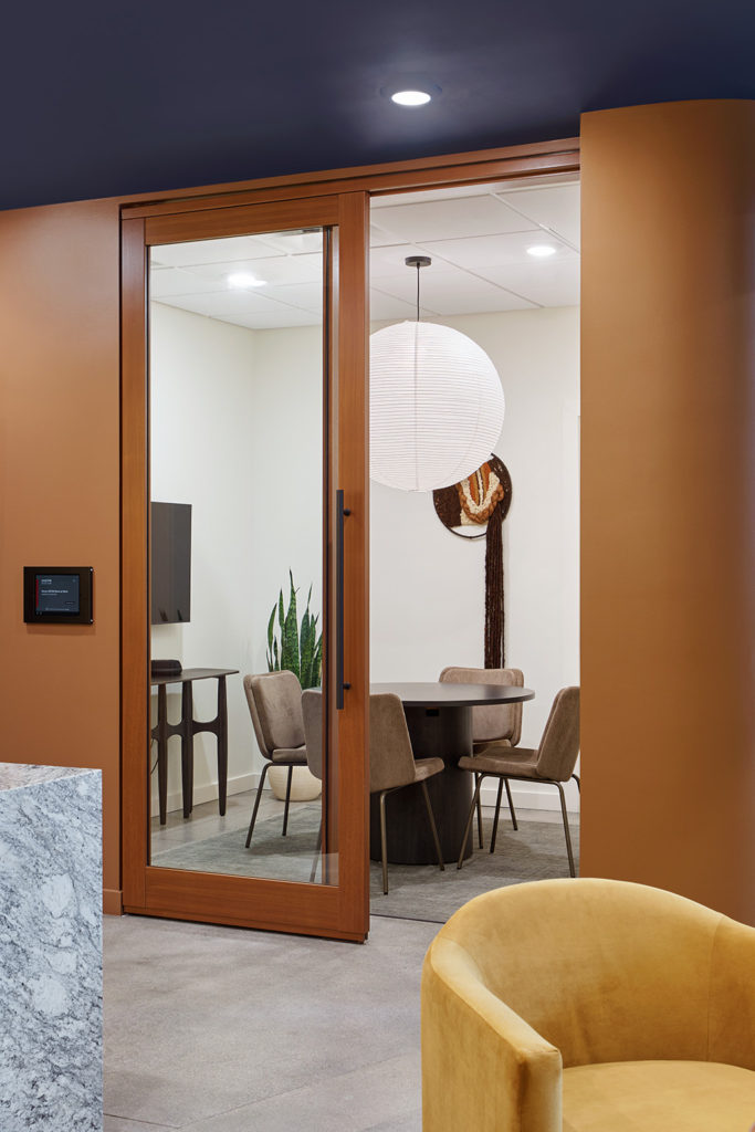 Small meeting room with grey Alfred Chairs.