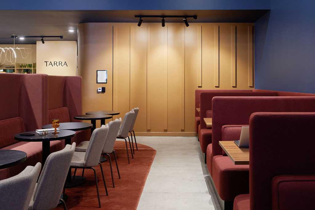 Row of grey Alfred chairs in informal collaboration space.