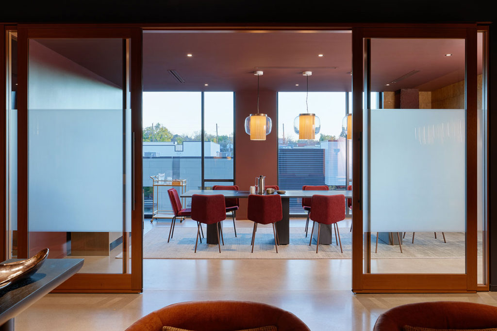 Meeting room with red Alfred Chairs.