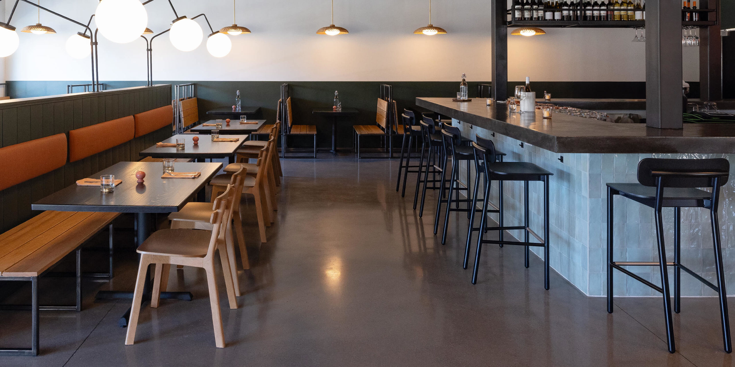 Restaurant bar with black Ferdinand Stools and Brooke chairs.