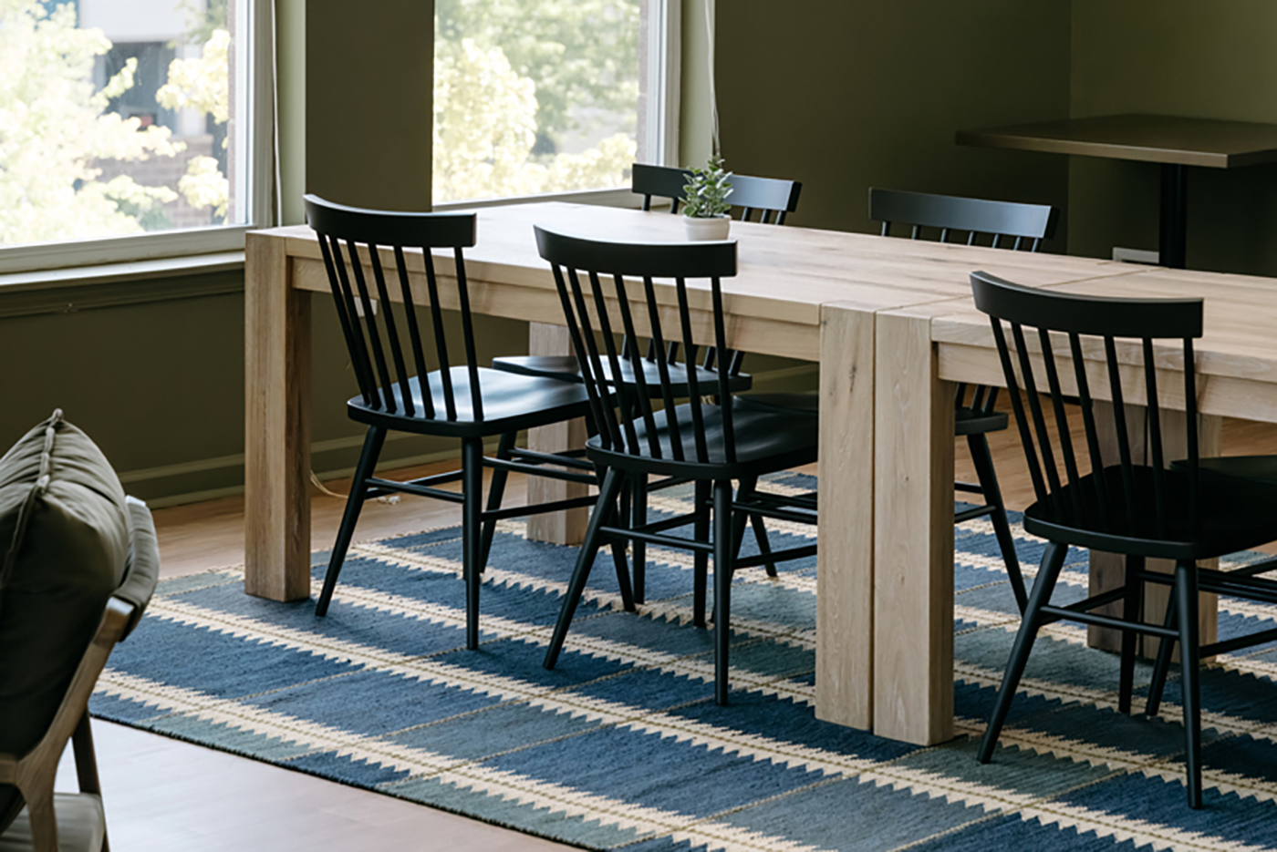 Black wood Hugh chairs in a student housing communal space