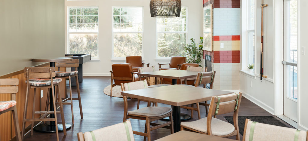 Student housing communal area featuring Brooke Barstool, Sigsbee fully upholstered chair, and Orbit Pedestal Table