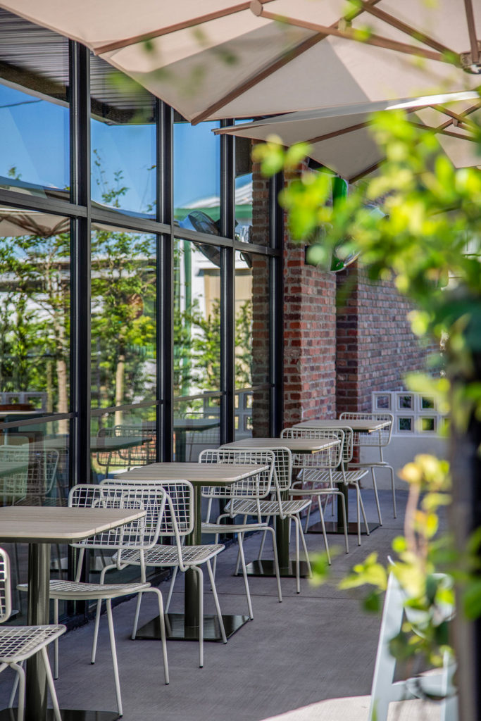 Opla Outdoor Chairs paired with Bowen Outdoor Pedestal table on a restaurant patio