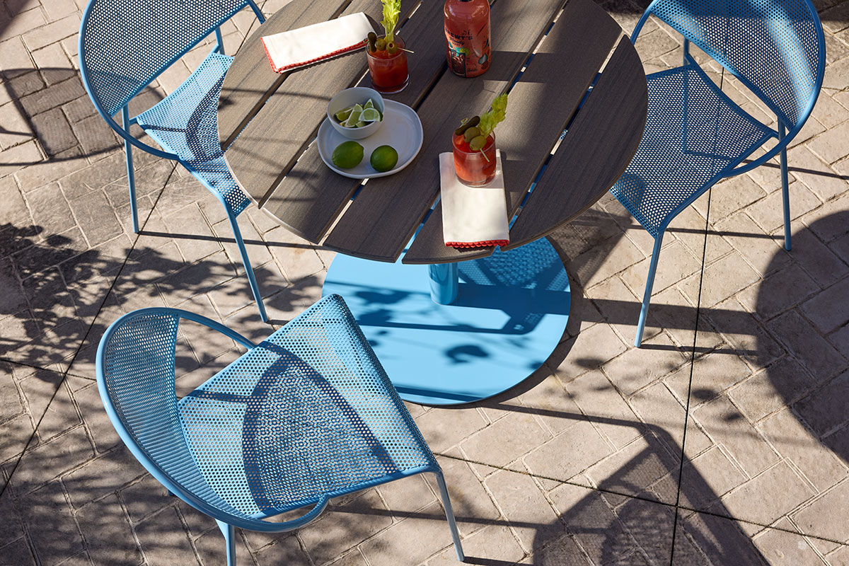 outdoor-patio-overhead-slatted-bowen-table-blue-hula-chair-landscape
