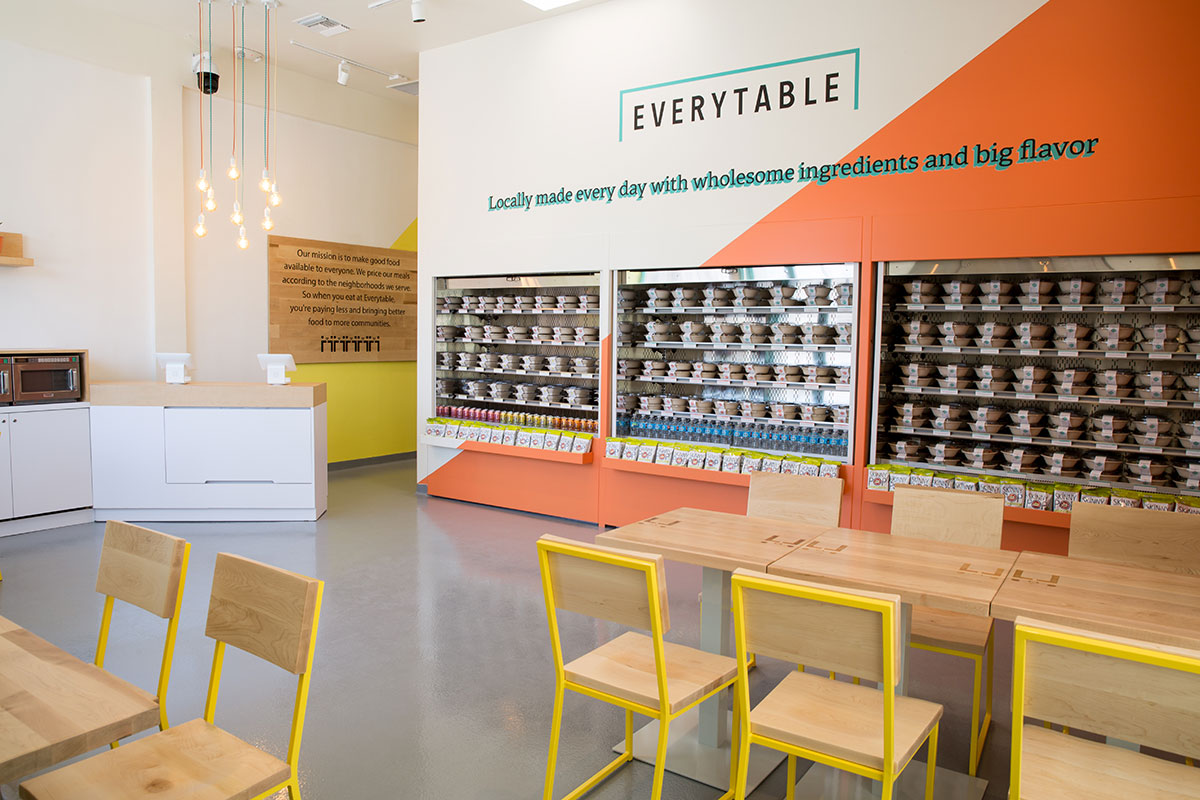 Brady Chairs bring the Everytable brand to life with bold yellow bases, while matching Pedestal Tables sport custom-engraved Everytable logos for that extra branded flair.