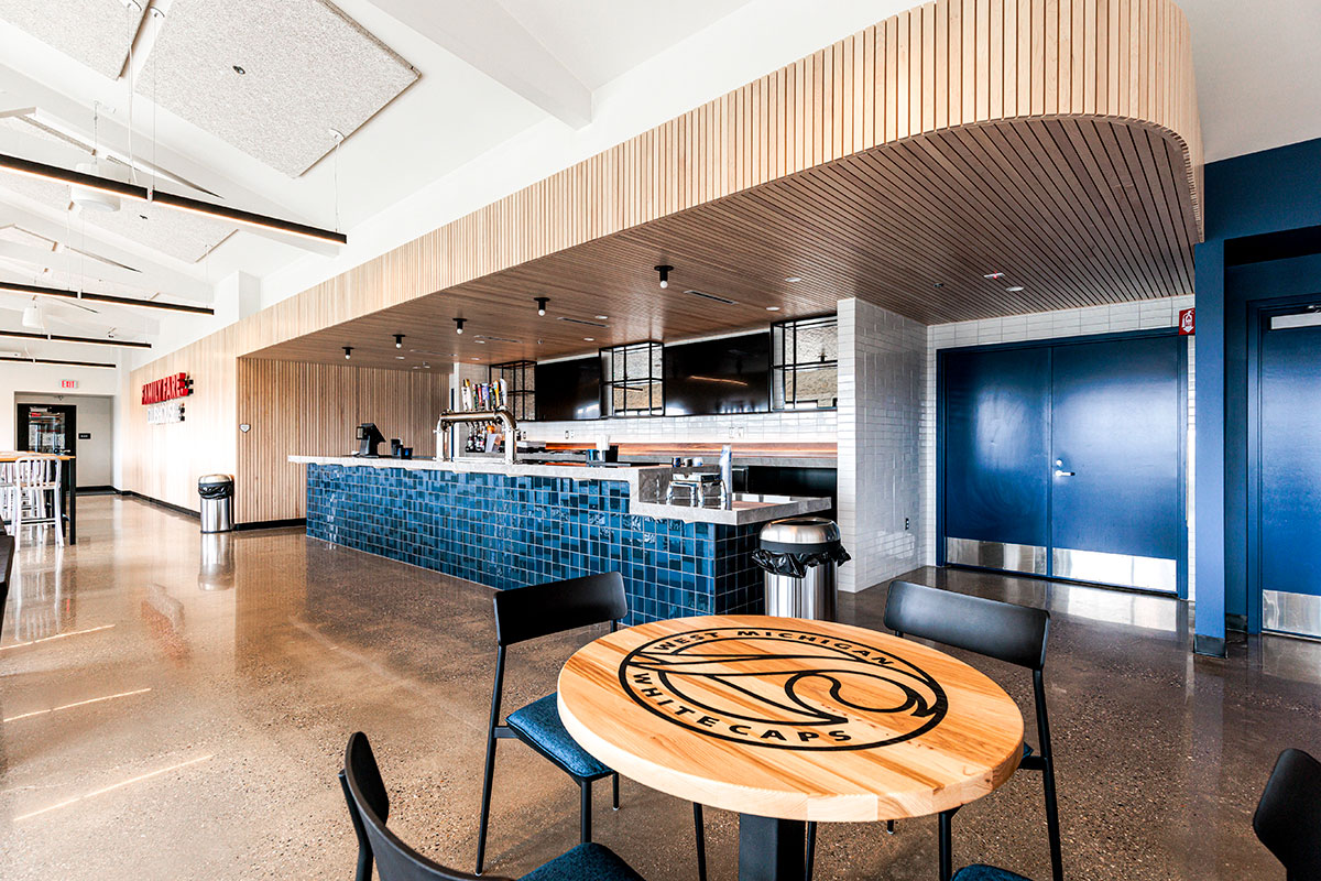 A Brady Pedestal Table built for game day glory—topped with solid hickory tough enough for nacho cheese and drink rings, plus the West Michigan Whitecaps logo engraved and backfilled in bold black. Photo by Carbon Stories. 