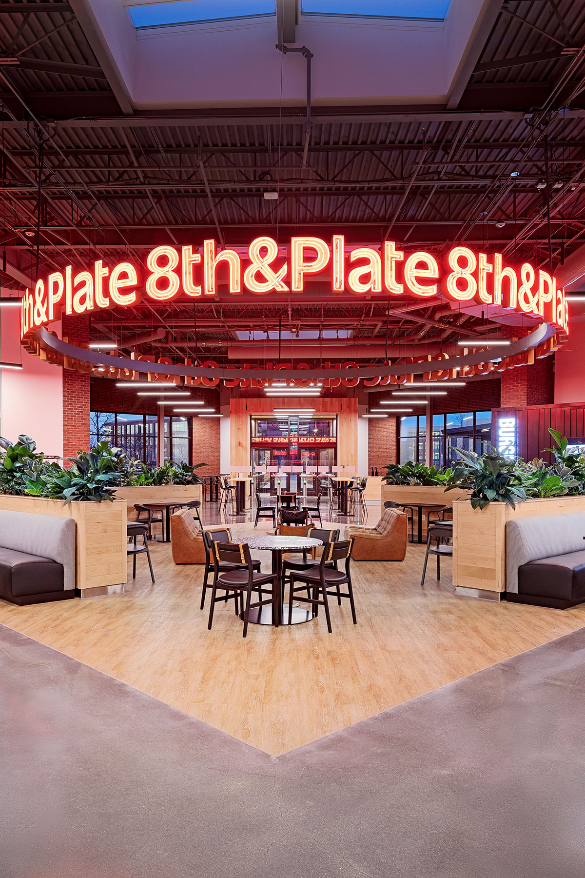 walmart-food-hall-gathering-area-neon-sign-sigsbee-strap-detail-dark-wood-chair-portrait Designed by Gensler & Porter. Photos courtesy of Walmart.